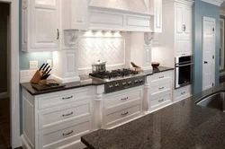 White kitchen with brown countertop photo in the interior