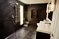 Photo of a bathroom with dark tiles