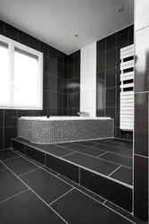 Photo of a bathroom with dark tiles