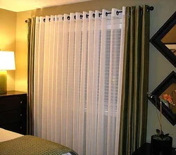 Curtains with eyelets in the bedroom interior