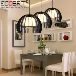 Modern chandeliers in the kitchen above the table photo