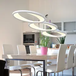 Modern chandeliers in the kitchen above the table photo