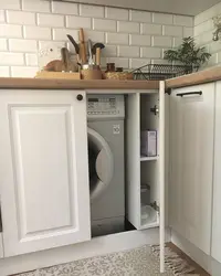 Washing machine in the kitchen under the countertop photo