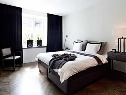 Dark bedroom interior with white wallpaper