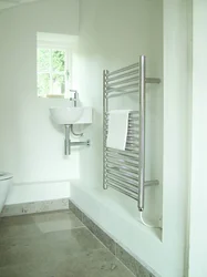 Electric heated towel rail in the bathroom photo