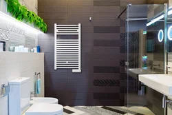 Electric heated towel rail in the bathroom photo