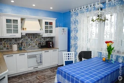 Blue curtains in the kitchen interior photo