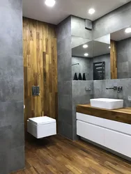 Bathroom design in gray tones with wood