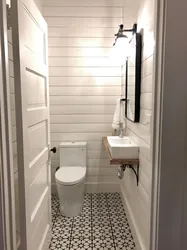 Interior Of A Toilet With A Sink Without A Bathtub Photo