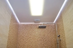 Illuminated ceiling in the bathroom photo in