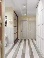 In the hallway there is a light floor in the interior photo