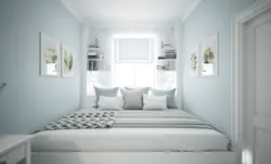 Bed along the wall in a small bedroom design photo