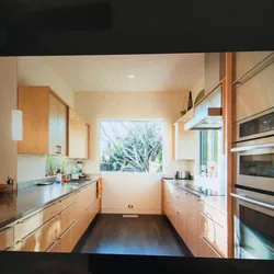 Photo Of A Narrow Kitchen In A House With A Window