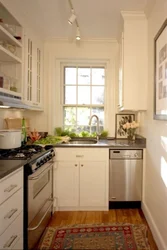 Photo Of A Narrow Kitchen In A House With A Window