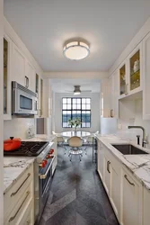 Photo of a narrow kitchen in a house with a window