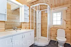 Bathtub in a wooden house with shower design