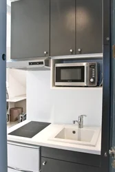 Photo of a kitchen with a microwave in a niche