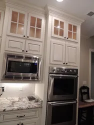 Photo of a kitchen with a microwave in a niche