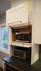 Photo of a kitchen with a microwave in a niche