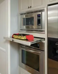 Photo of a kitchen with a microwave in a niche