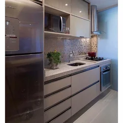Silver refrigerator in the kitchen interior