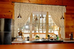 Curtains in the kitchen in a wooden house photo