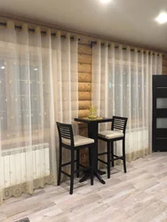 Curtains in the kitchen in a wooden house photo