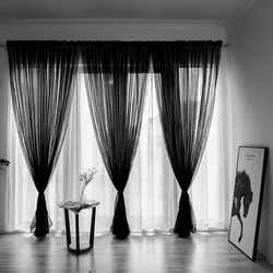 Black curtains in the kitchen interior