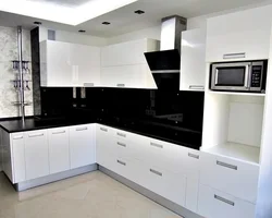 White kitchen with black handles and black countertop photo