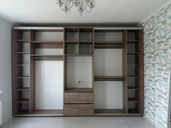 Built-in wardrobe in the living room on the entire wall photo