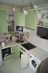 Corner kitchen design with refrigerator and dishwasher