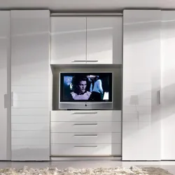 Sliding wardrobes with a niche for a TV in the bedroom photo