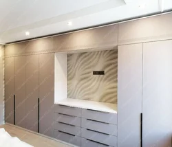 Sliding wardrobes with a niche for a TV in the bedroom photo