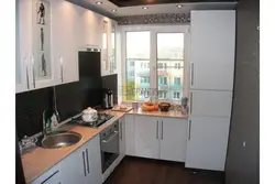 Kitchen design 2 by 2 meters with a window and a refrigerator