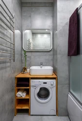 Washing machine under the sink in the bathroom design