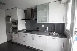 White Kitchen With Gray Refrigerator Photo