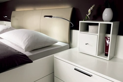 Nightstands near the bed in the bedroom photo