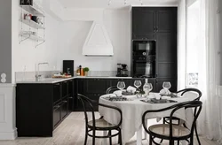 White kitchen black table in the interior