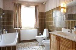 Interior of a bathroom with a toilet in a house with a window