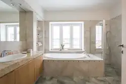 Interior of a bathroom with a toilet in a house with a window