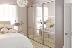 Wardrobe in the bedroom with a mirror for two doors photo