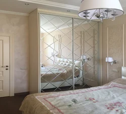 Wardrobe in the bedroom with a mirror for two doors photo