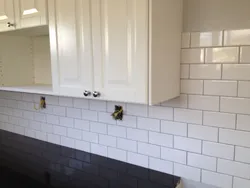 Grout on white tiles in the kitchen photo