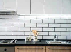 Grout on white tiles in the kitchen photo