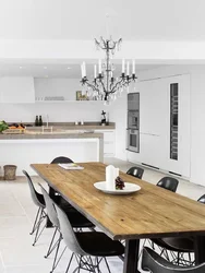 White table with black chairs in the kitchen interior