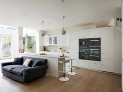 Photo of a living room kitchen with a sofa at the table