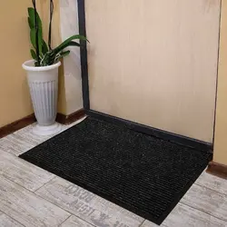 Rug by the door in the hallway photo