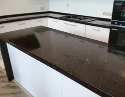 Black glossy countertop in the kitchen photo