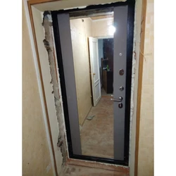 Photo of a door with a mirror from an apartment