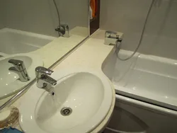 Bathroom with one faucet for bathtub and sink photo